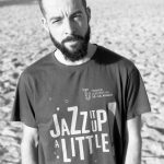 Guide Pedro in casual summer attire on a sunny beach along the northern Norwegian coastline.